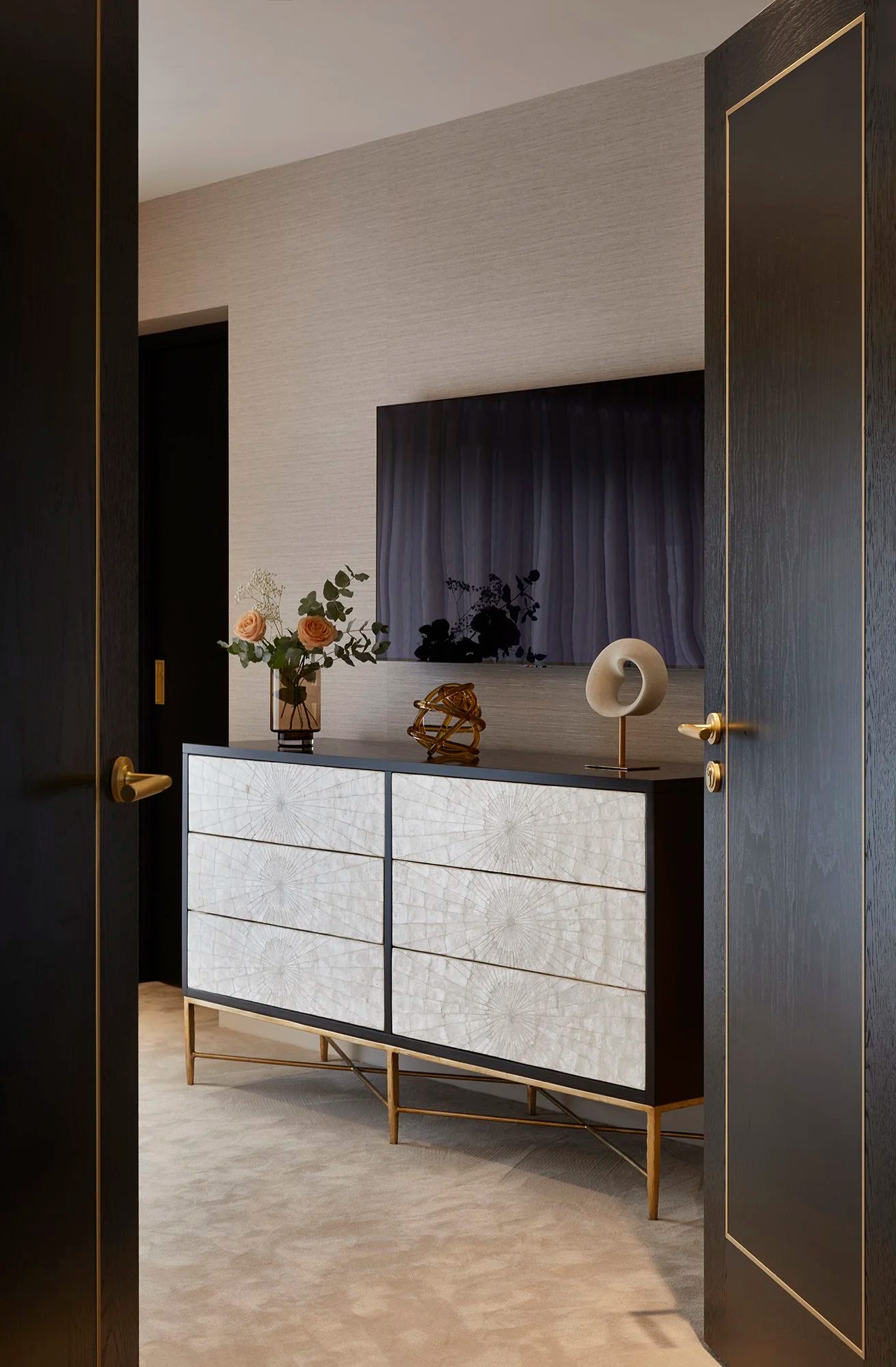 Dark timber dresser with mother-of-pearl drawer fronts and brass handles