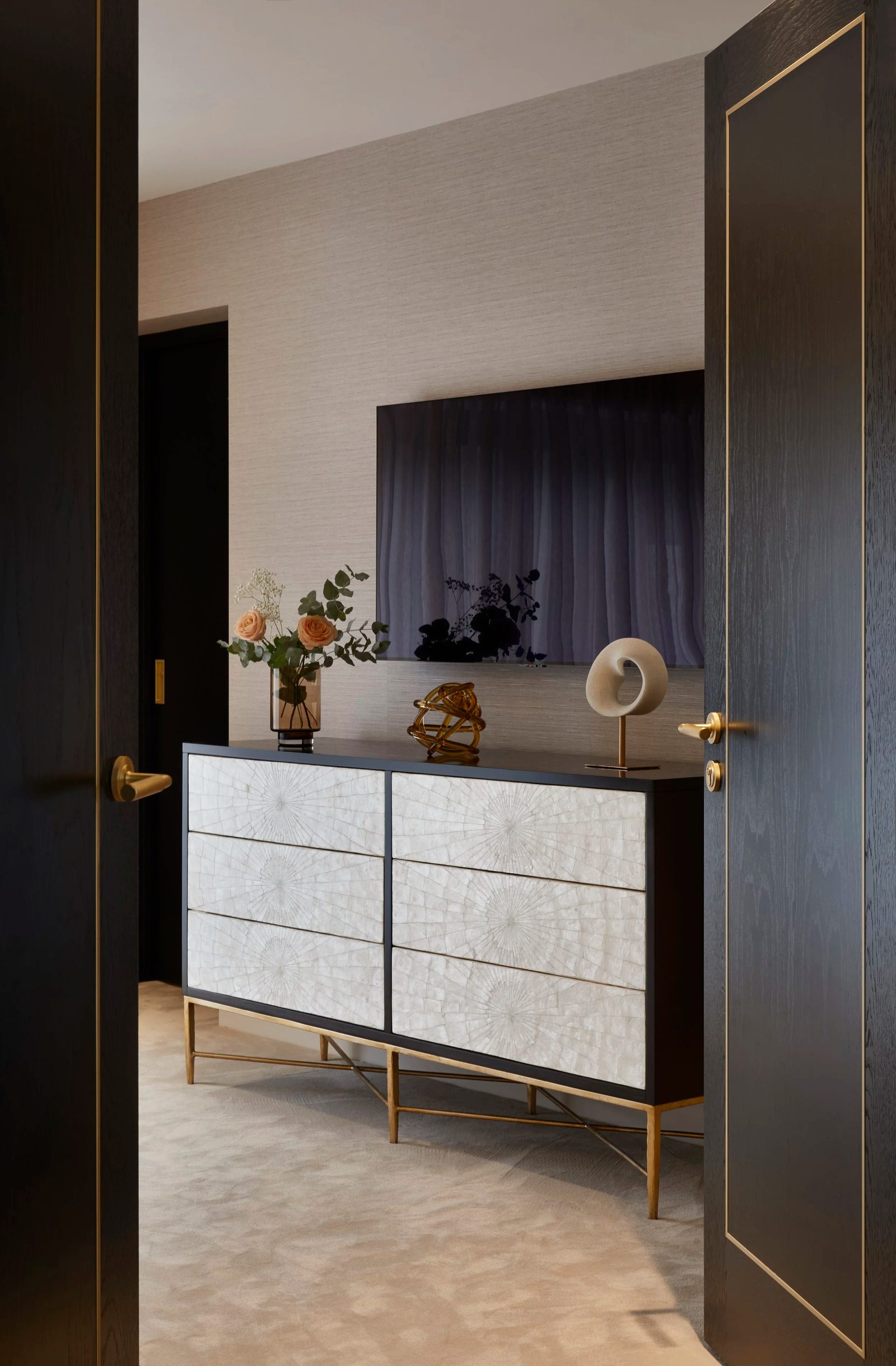 Dark timber doors framing a dresser with mother-of-pearl drawers